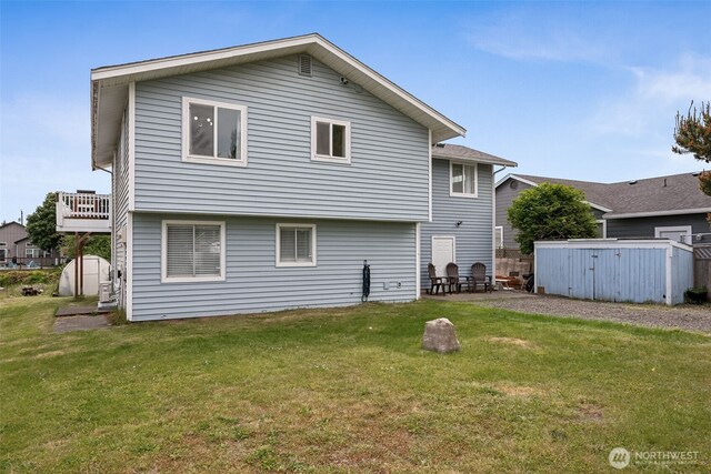177 N Razor Clam Dr SW, Ocean Shores, WA 98569 - rear view of property with a lawn