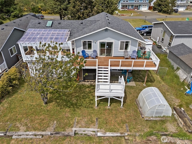 177 N Razor Clam Dr SW, Ocean Shores, WA 98569 - rear view of house featuring an exterior structure, roof with shingles, a deck, an outdoor structure, and solar panels