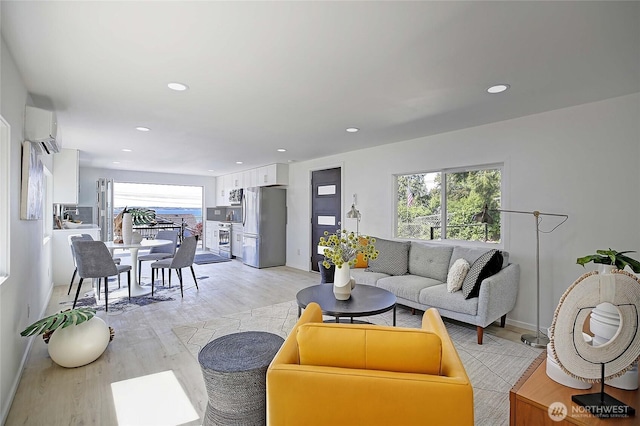 275 Maple St, Camano Island, WA 98282 - living room featuring light wood-type flooring, a wall mounted AC, recessed lighting, and baseboards