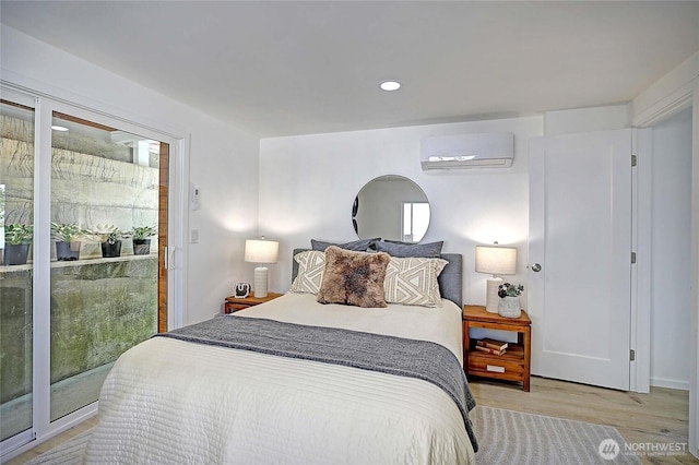 275 Maple St, Camano Island, WA 98282 - bedroom featuring a wall unit AC, light wood-style flooring, and recessed lighting