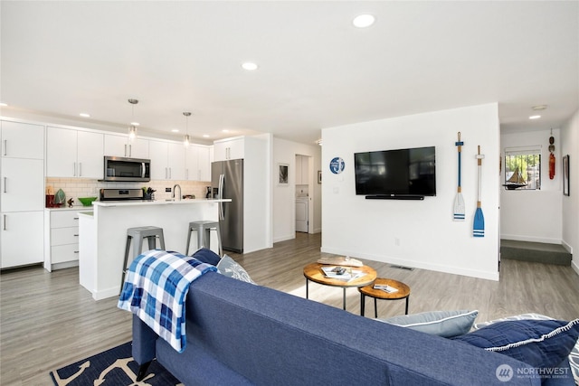 817 Kitsap St, Port Orchard, WA 98366 - living area featuring light wood-style flooring, recessed lighting, and baseboards
