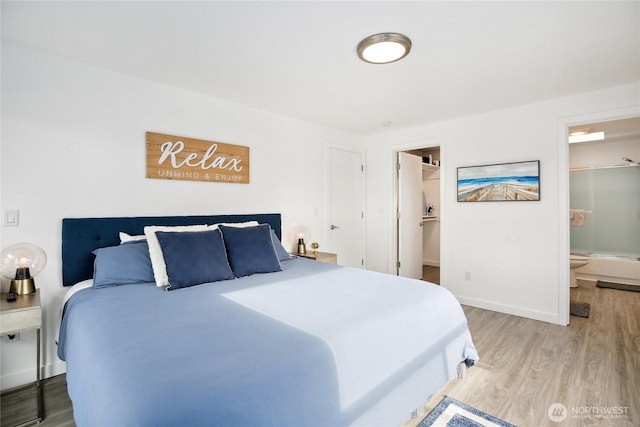 817 Kitsap St, Port Orchard, WA 98366 - bedroom with light wood-type flooring, a spacious closet, baseboards, and ensuite bathroom