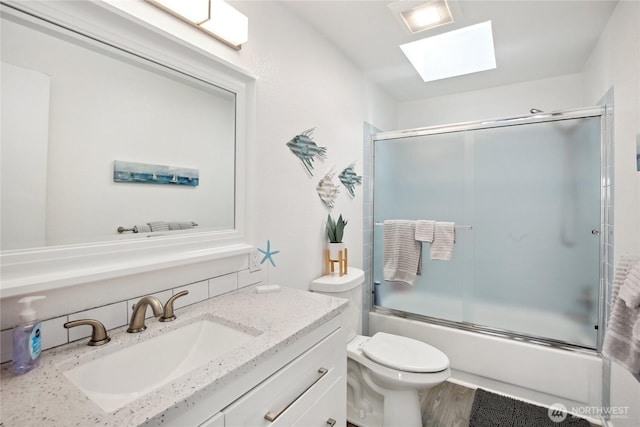 817 Kitsap St, Port Orchard, WA 98366 - full bath featuring a skylight, enclosed tub / shower combo, vanity, toilet, and wood finished floors