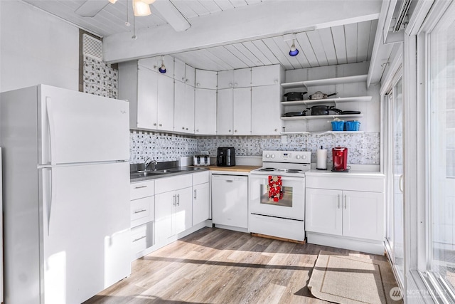 7491 Birch Bay Dr, Blaine, WA 98230 - kitchen featuring white appliances, white cabinets, light wood-style floors, backsplash, and wood ceiling with exposed beams