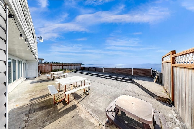 7491 Birch Bay Dr, Blaine, WA 98230 - fenced backyard with a patio area and a water view