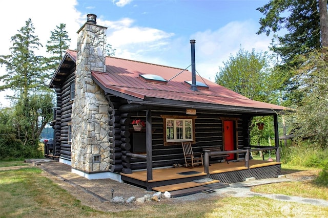 54 Center View Dr, Decatur Island, WA 98221 - rear view of property featuring log exterior, a chimney, metal roof, and covered porch