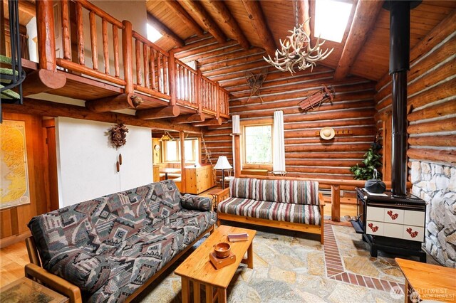 54 Center View Dr, Decatur Island, WA 98221 - living area featuring a wood stove, a chandelier, wood ceiling, and log walls