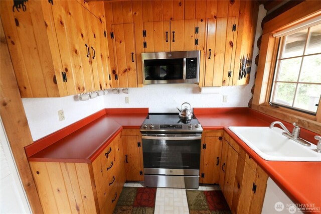 54 Center View Dr, Decatur Island, WA 98221 - kitchen with appliances with stainless steel finishes, a sink, and brown cabinetry