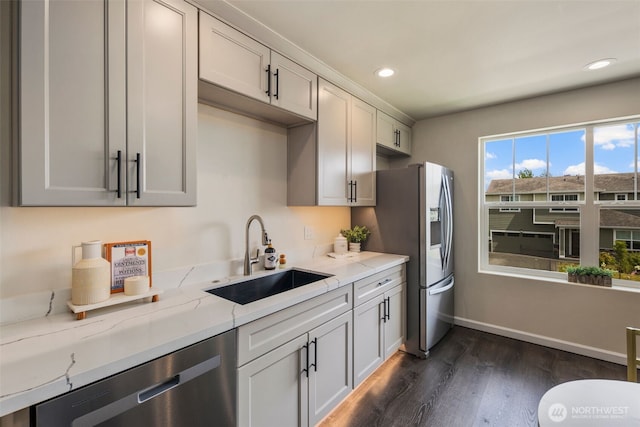 14204 67th Avenue Ct E, Puyallup, WA 98373 - kitchen with a sink, appliances with stainless steel finishes, dark wood-style floors, baseboards, and light stone countertops