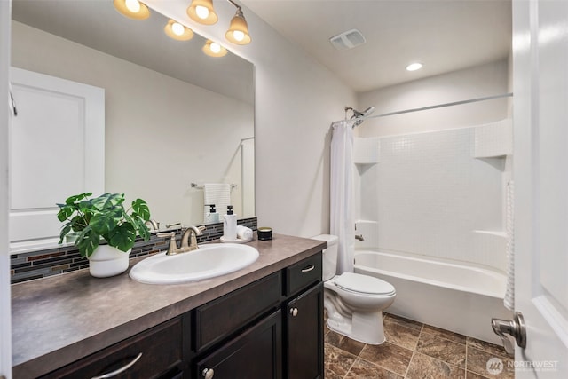 14204 67th Avenue Ct E, Puyallup, WA 98373 - full bathroom featuring vanity, shower / tub combo, toilet, decorative backsplash, and stone finish floors