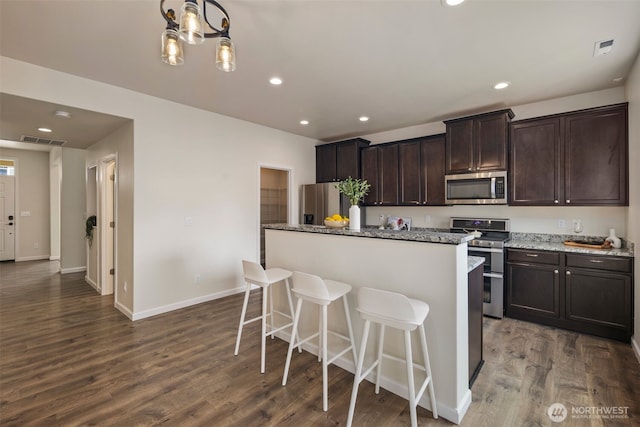 14204 67th Avenue Ct E, Puyallup, WA 98373 - kitchen featuring stainless steel appliances, a kitchen island, dark wood finished floors, recessed lighting, and dark brown cabinets
