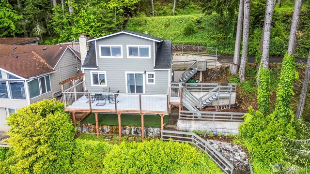 1201 Summit Lake Shore Rd NW, East Olympia, WA 98502 - rear view of house featuring stairway, a wooden deck, a shingled roof, and a chimney
