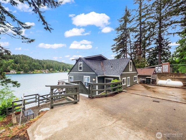 1201 Summit Lake Shore Rd NW, East Olympia, WA 98502 - rear view of house featuring a water view, a forest view, and a shingled roof