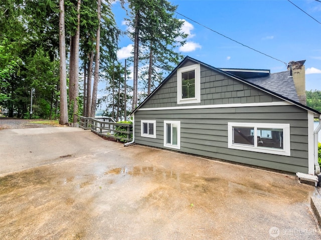 1201 Summit Lake Shore Rd NW, East Olympia, WA 98502 - view of property exterior with a chimney