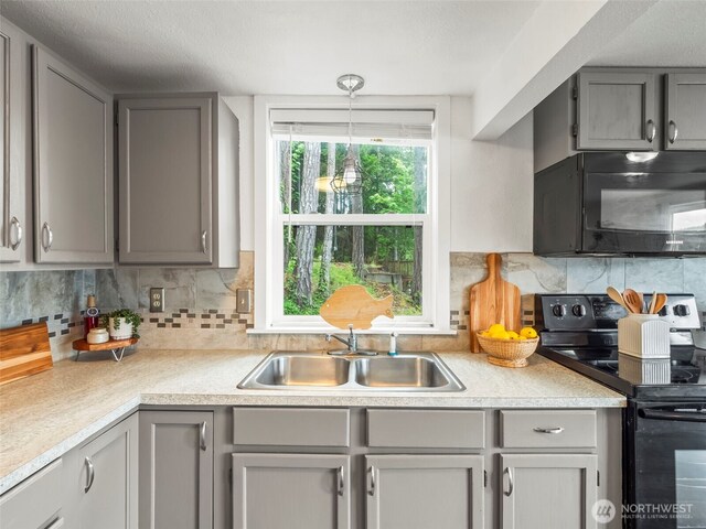 1201 Summit Lake Shore Rd NW, East Olympia, WA 98502 - kitchen with black appliances, gray cabinetry, a sink, and light countertops