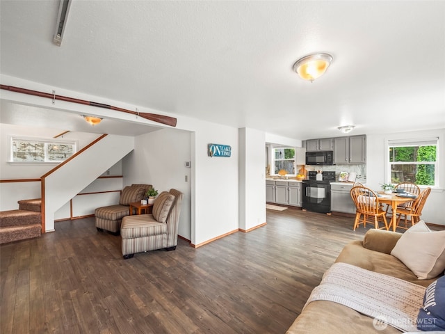 1201 Summit Lake Shore Rd NW, East Olympia, WA 98502 - living room featuring dark wood-style floors, stairs, and baseboards