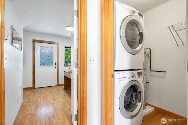 6348 34th Ave SW Unit C, Seattle, WA 98126 - laundry room featuring stacked washer / drying machine, light wood-style floors, and baseboards