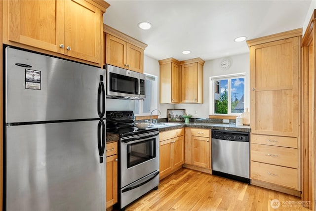 6348 34th Ave SW Unit C, Seattle, WA 98126 - kitchen featuring appliances with stainless steel finishes, a sink, light wood finished floors, light brown cabinetry, and recessed lighting