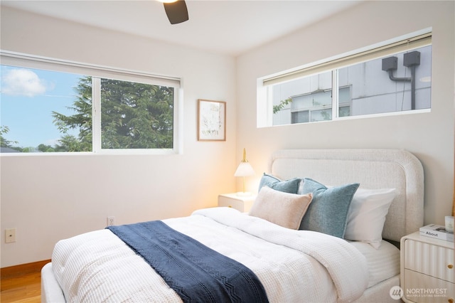 6348 34th Ave SW Unit C, Seattle, WA 98126 - bedroom featuring multiple windows, wood finished floors, and a ceiling fan