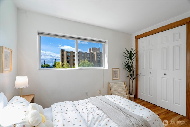 6348 34th Ave SW Unit C, Seattle, WA 98126 - bedroom with multiple windows, wood finished floors, and a closet