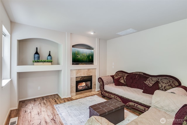 11710 SE 310th St, Auburn, WA 98092 - living area featuring a fireplace, wood finished floors, and baseboards