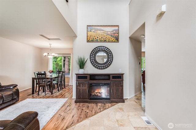 11710 SE 310th St, Auburn, WA 98092 - living room featuring a chandelier, baseboards, and a high ceiling