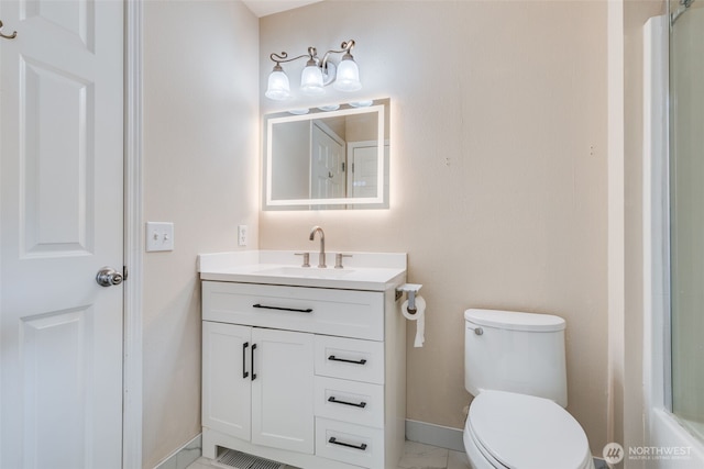 11710 SE 310th St, Auburn, WA 98092 - bathroom featuring vanity, toilet, baseboards, marble finish floors, and a shower
