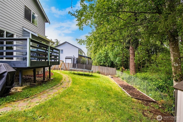 11710 SE 310th St, Auburn, WA 98092 - view of yard featuring a trampoline and a deck
