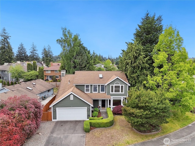 1015 SW 348th Pl, Federal Way, WA 98023 - traditional-style home with driveway, an attached garage, roof with shingles, and a chimney