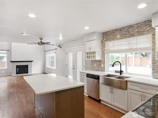 1015 SW 348th Pl, Federal Way, WA 98023 - kitchen featuring stainless steel dishwasher, a sink, ceiling fan, light countertops, and a kitchen island