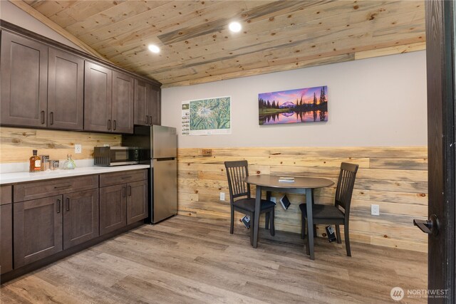 34208 343rd Avenue Ct E, Ashford, WA 98304 - kitchen with stainless steel appliances, wood ceiling, dark brown cabinetry, wood walls, and light wood-style flooring