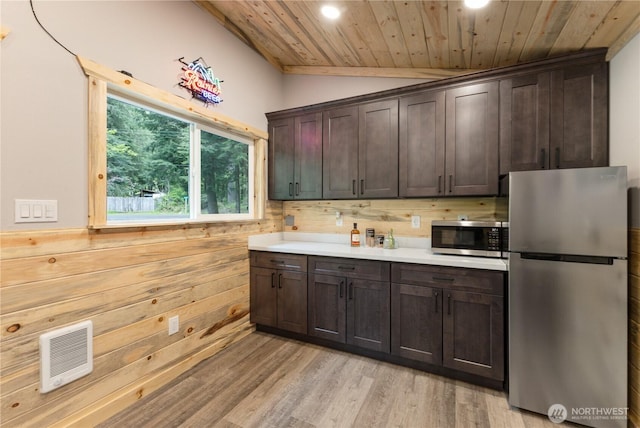 34208 343rd Avenue Ct E, Ashford, WA 98304 - kitchen featuring stainless steel appliances, wooden ceiling, heating unit, dark brown cabinetry, and wood walls
