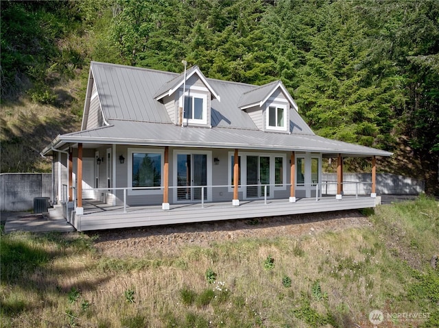 46 Wildwood Ln, Cathlamet, WA 98612 - view of front of home with central AC, covered porch, metal roof, and a wooded view