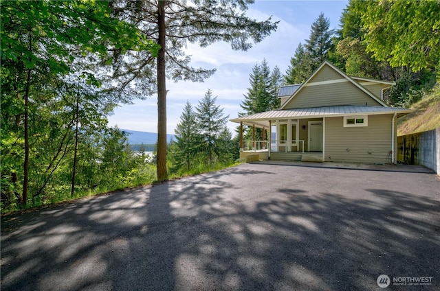 46 Wildwood Ln, Cathlamet, WA 98612 - rear view of house with covered porch, metal roof, driveway, and a standing seam roof