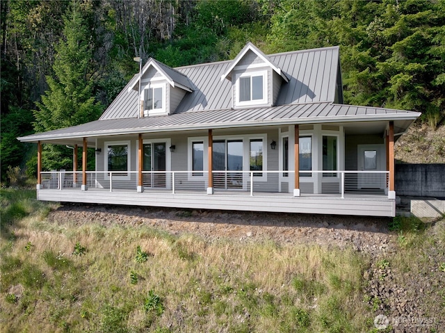 46 Wildwood Ln, Cathlamet, WA 98612 - back of house with a standing seam roof, metal roof, covered porch, and a forest view