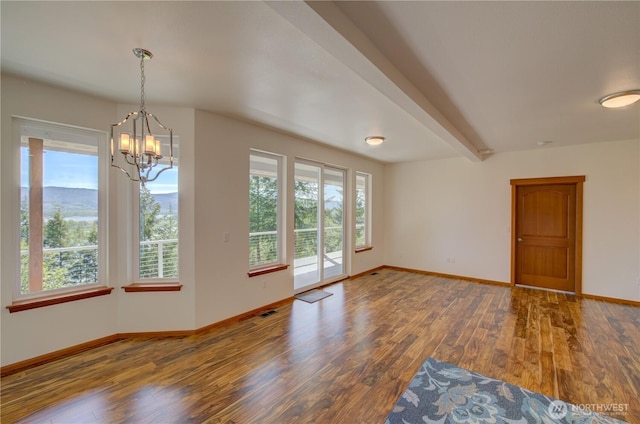 46 Wildwood Ln, Cathlamet, WA 98612 - unfurnished room featuring plenty of natural light, a chandelier, baseboards, and beam ceiling