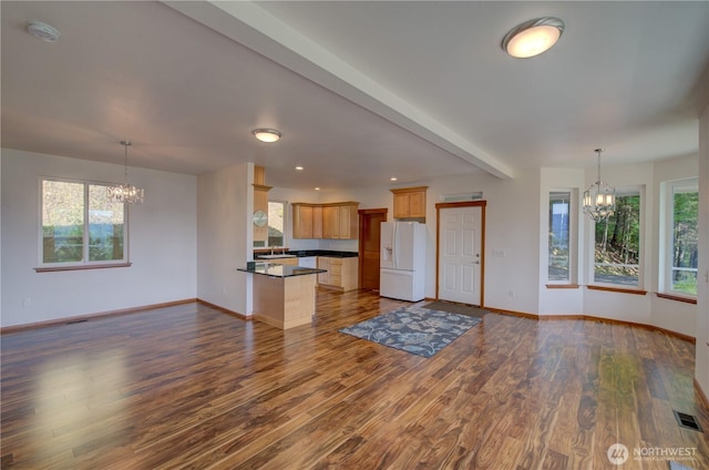 46 Wildwood Ln, Cathlamet, WA 98612 - unfurnished living room with a chandelier, baseboards, dark wood-style flooring, plenty of natural light, and recessed lighting