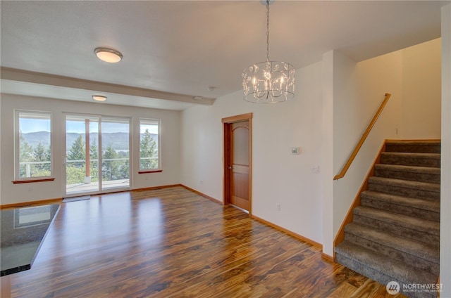 46 Wildwood Ln, Cathlamet, WA 98612 - unfurnished dining area featuring wood finished floors, stairway, baseboards, and a chandelier