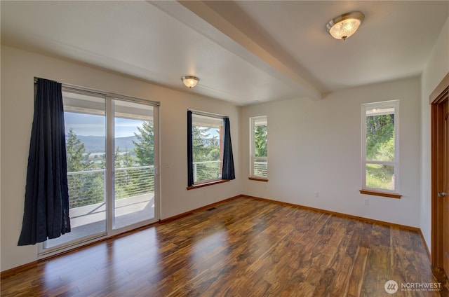 46 Wildwood Ln, Cathlamet, WA 98612 - unfurnished room featuring plenty of natural light, wood finished floors, baseboards, and beamed ceiling
