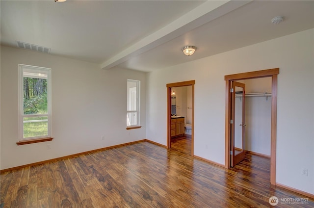 46 Wildwood Ln, Cathlamet, WA 98612 - unfurnished bedroom featuring a spacious closet, dark wood finished floors, baseboards, ensuite bath, and a closet