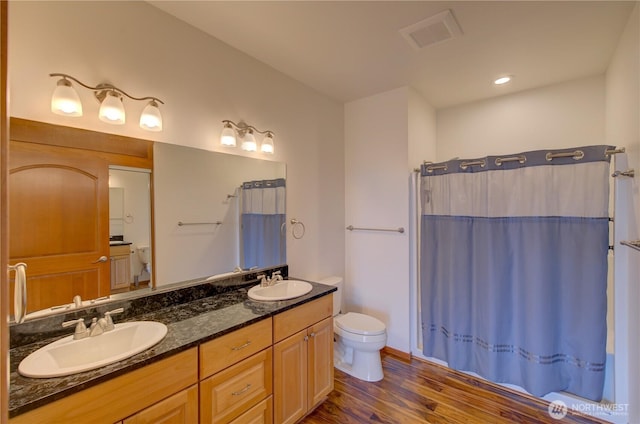 46 Wildwood Ln, Cathlamet, WA 98612 - bathroom with toilet, double vanity, wood finished floors, and curtained shower