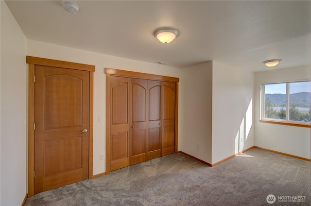 46 Wildwood Ln, Cathlamet, WA 98612 - unfurnished bedroom featuring carpet flooring, baseboards, and a closet