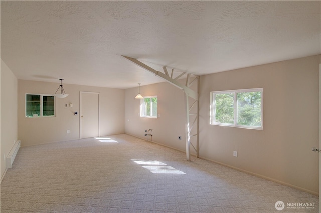 46 Wildwood Ln, Cathlamet, WA 98612 - carpeted empty room with a baseboard heating unit, a textured ceiling, and baseboards