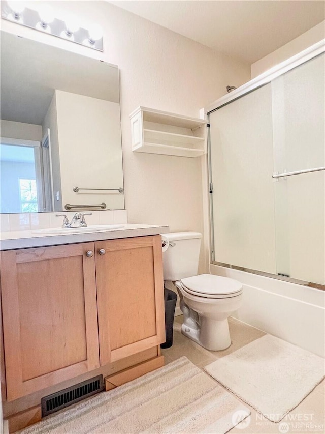 7732 Fairway Ave SE Unit 203, Snoqualmie, WA 98065 - bathroom featuring toilet, vanity, shower / bath combination with glass door, and tile patterned flooring