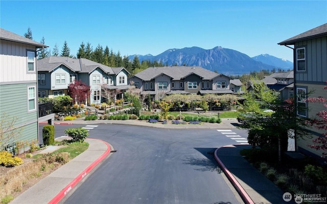 7732 Fairway Ave SE Unit 203, Snoqualmie, WA 98065 - view of asphalt street with sidewalks, a residential view, curbs, and a mountain view