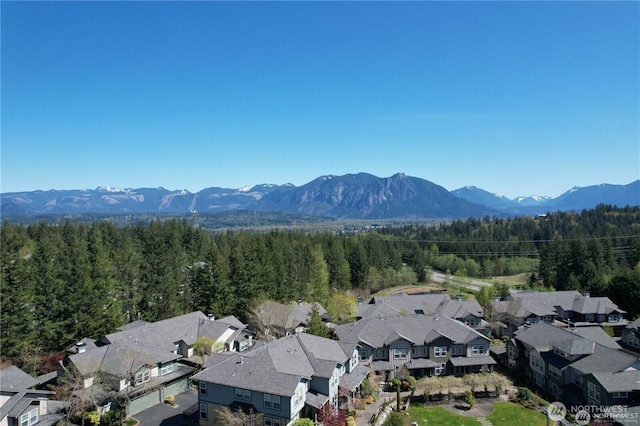 7732 Fairway Ave SE Unit 203, Snoqualmie, WA 98065 - aerial perspective of suburban area featuring a mountain backdrop and a forest