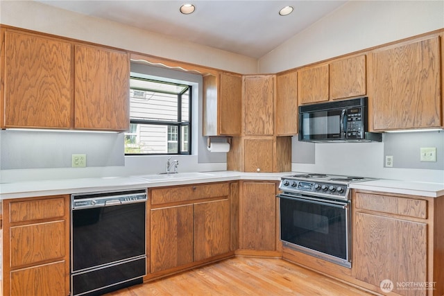 1515 19th Ave, Longview, WA 98632 - kitchen with black appliances, a sink, light countertops, light wood-style flooring, and vaulted ceiling