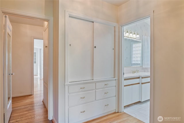 1515 19th Ave, Longview, WA 98632 - hallway with light wood-style flooring, a sink, and baseboards