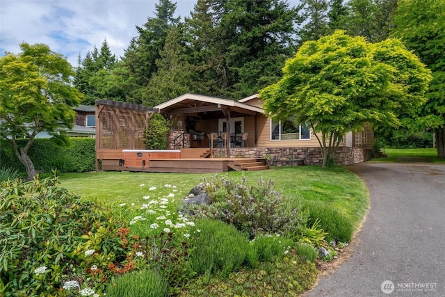 2570 Island View Ln, Lummi Island, WA 98262 - view of front of home with stone siding, a front yard, driveway, and a deck