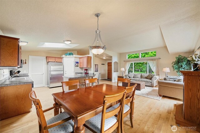 2570 Island View Ln, Lummi Island, WA 98262 - dining area featuring light wood finished floors and a skylight